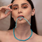 woman wearing blue opal necklace