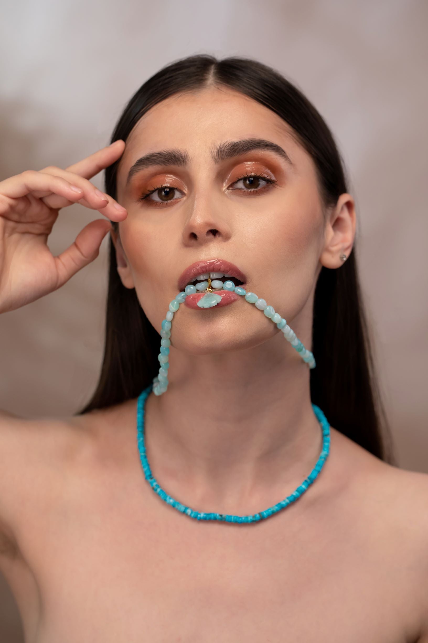 woman wearing blue opal necklace