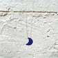 Half moon lapis lazuli necklace with a deep blue crescent shaped stone 