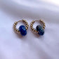 Pair of gold huggie earrings with lapis lazuli gemstones