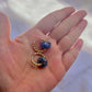 Pair of gold huggie earrings with lapis lazuli gemstones