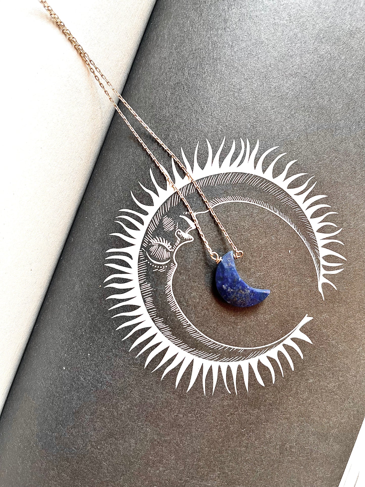 Half moon lapis lazuli necklace with a deep blue crescent shaped stone