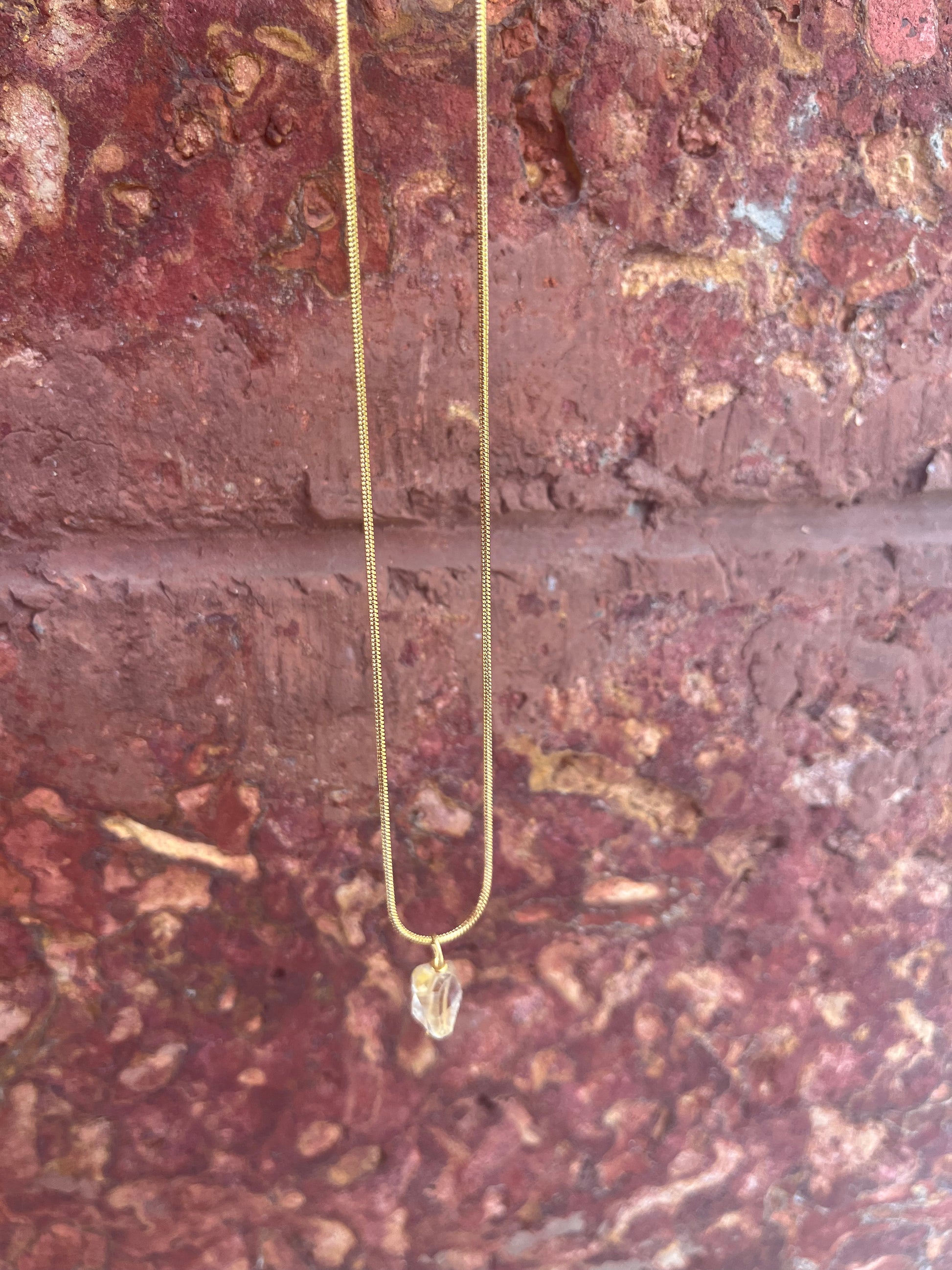 Golden citrine necklace with a faceted gemstone pendant on a delicate gold chain