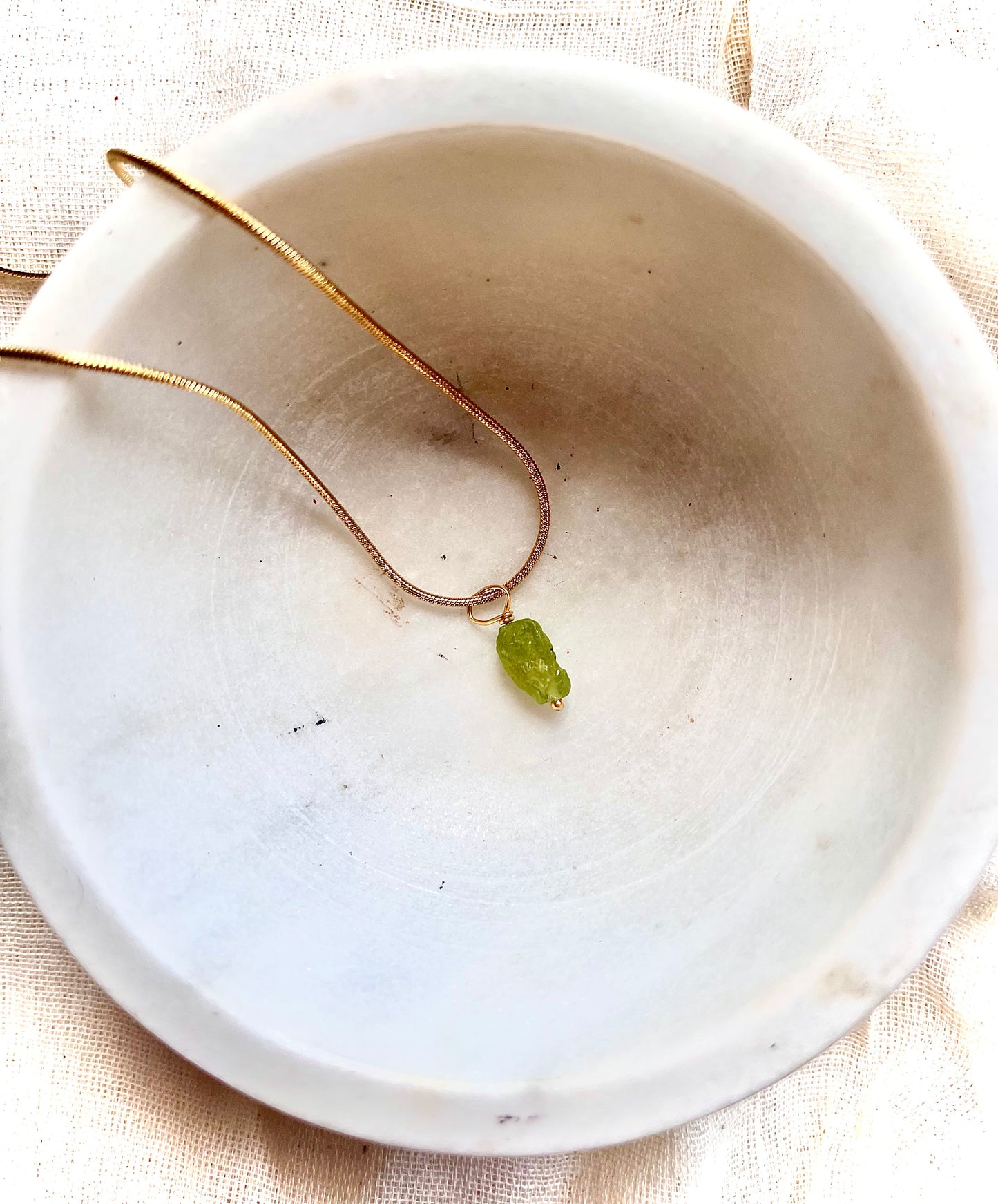 Peridot necklace featuring a sparkling green gemstone pendant on a delicate chain